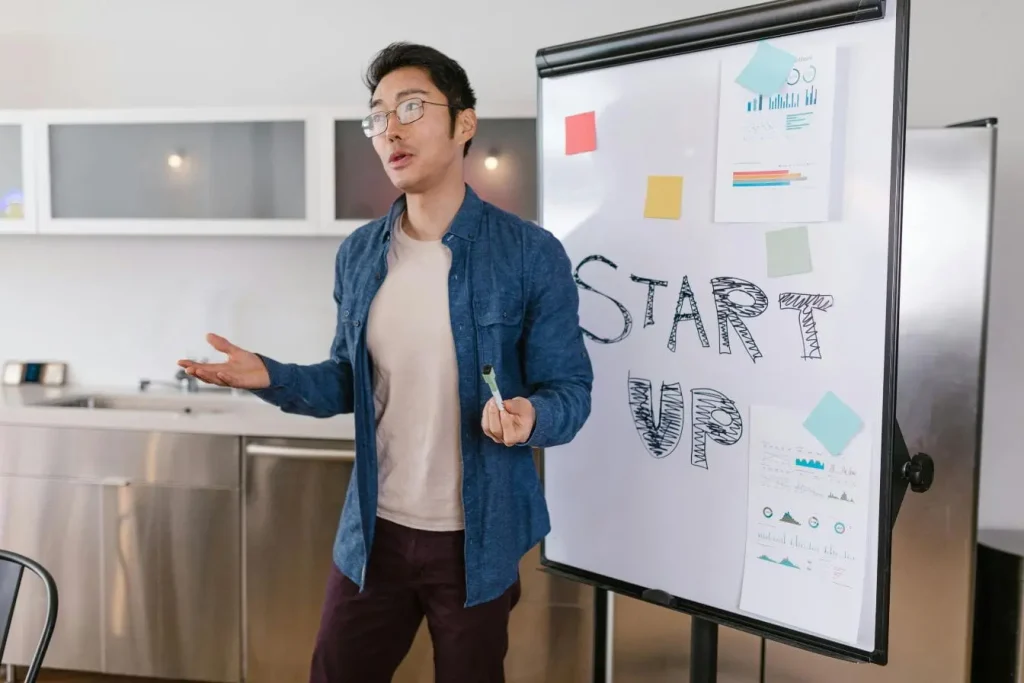 Personne présentant tableau blanc avec mot startup écrit, image illustrant un Term Sheet.