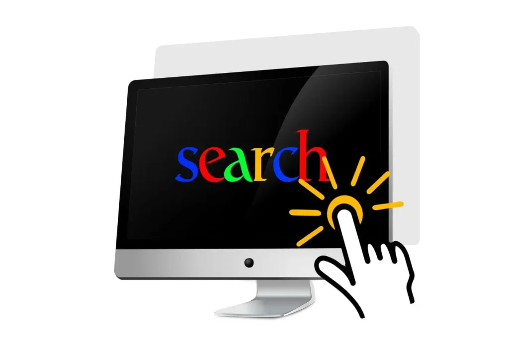 Écran affichant mot SEARCH en couleurs vives avec main cliquant, reflet d’une stratégie digitale comparant SEO et SEA.